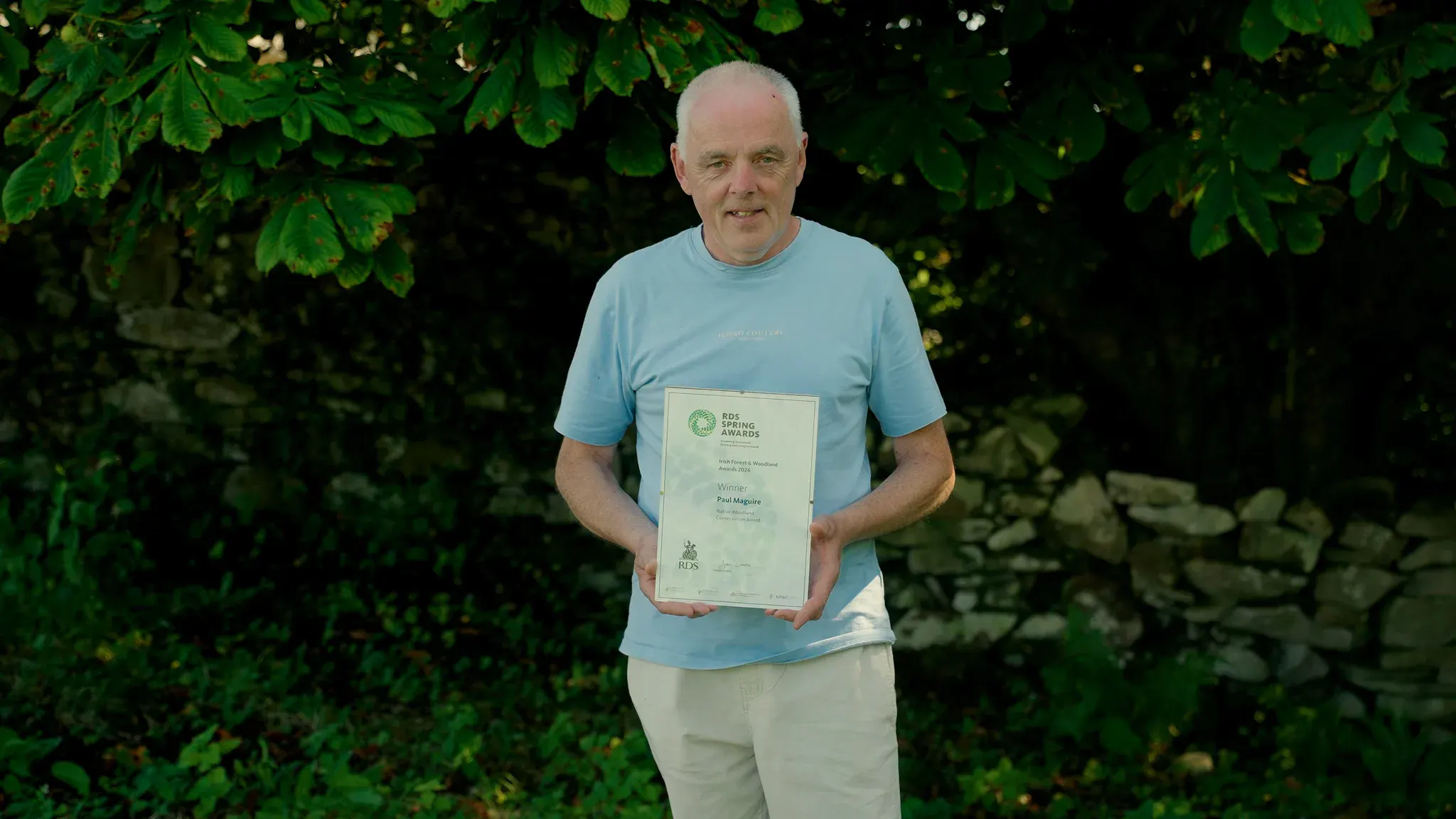 Paul Maguire holding the Native Woodland Conservation Award